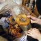Person holding bagel they pulled out of trash bag